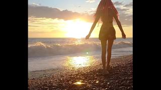 Sunset girl at the sea beach